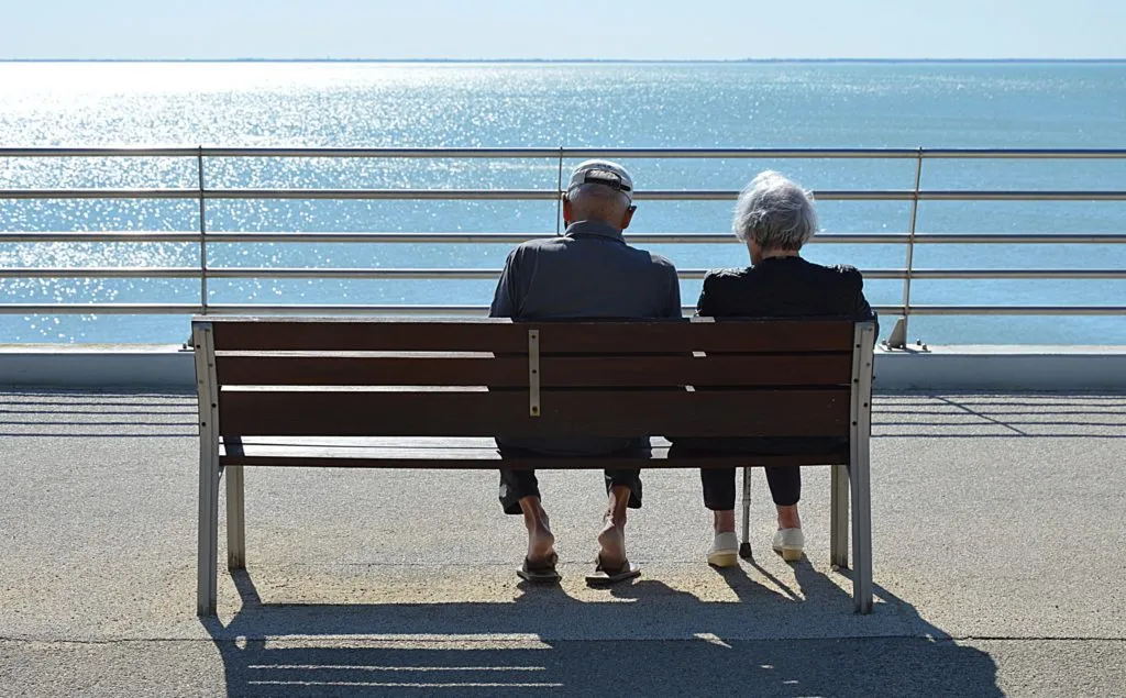 An older couple sitting together outdoors